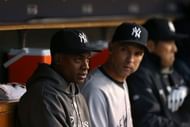 L-R: Curtis Granderson and Raul Ibanez of the New York Yankees look on from the dugout late in the game